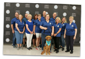 a comfort dog joining his volunteer group of handler